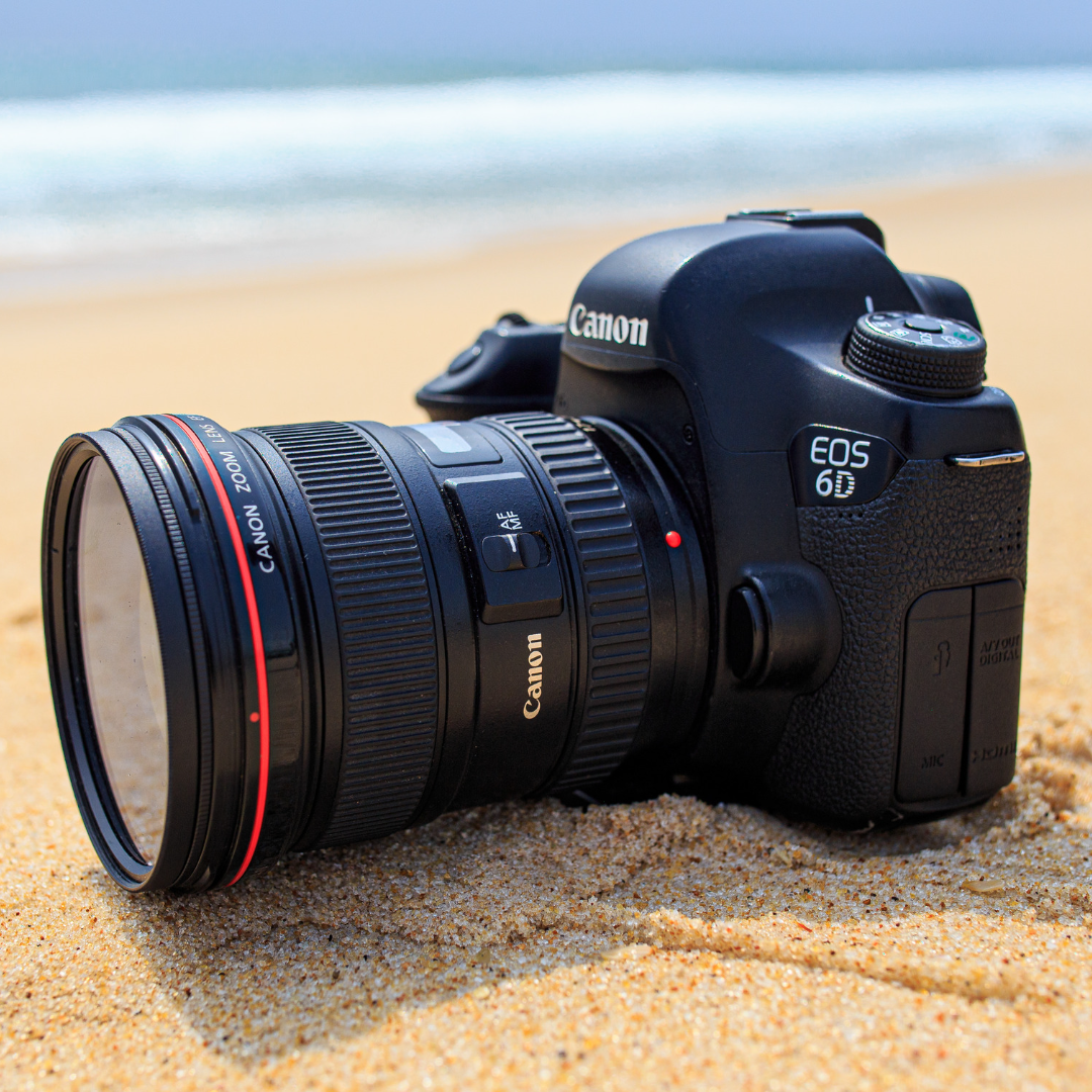 camera sitting in the sand