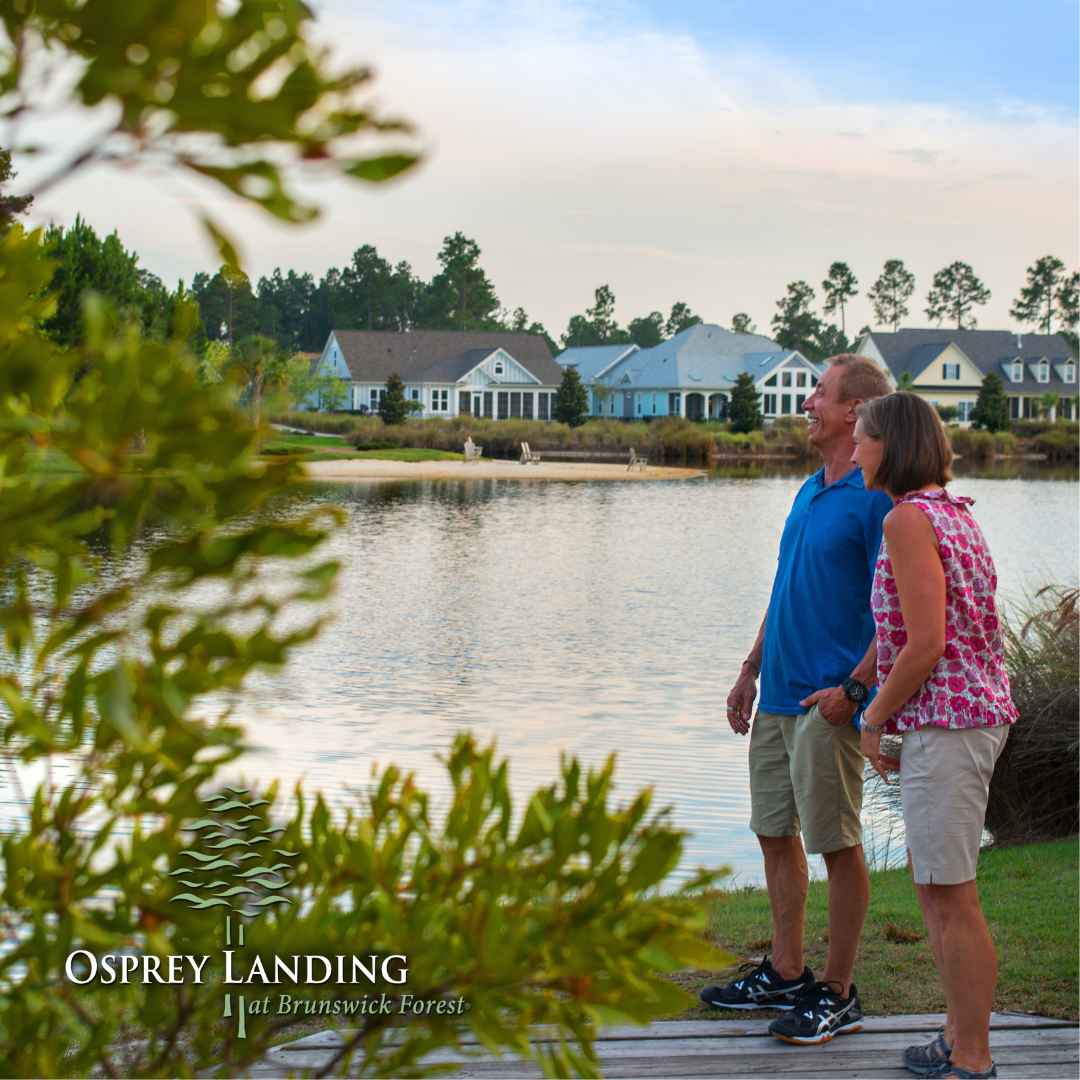 a couple standing in a neighborhood looking out to a lake